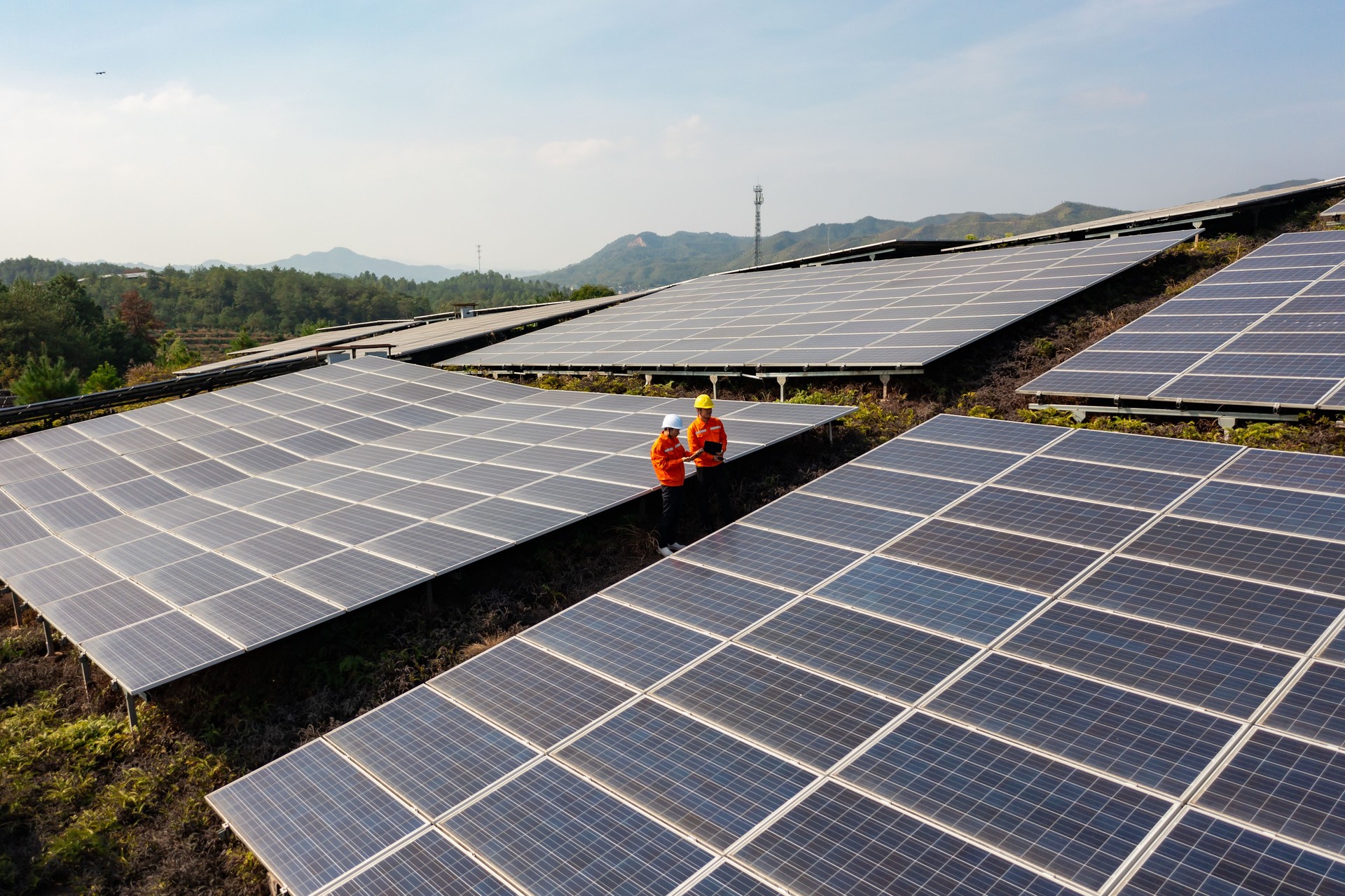 Zwei Arbeiter patrouillieren im Solarkraftwerk